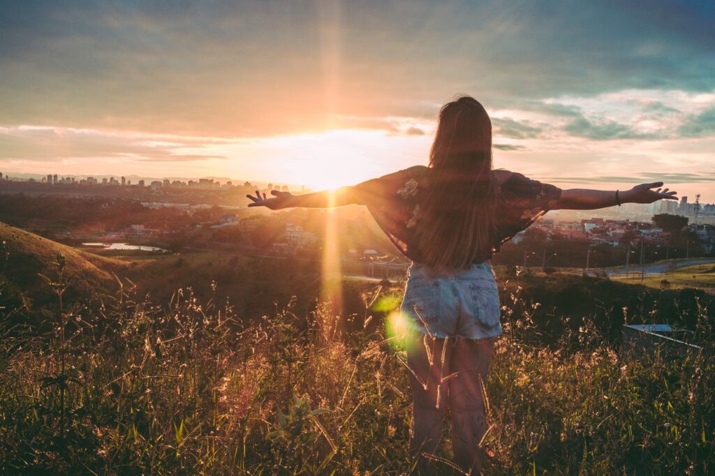 Woman Stands On Mountain Over Field Under Cloudy Sky At 847483 1024x682