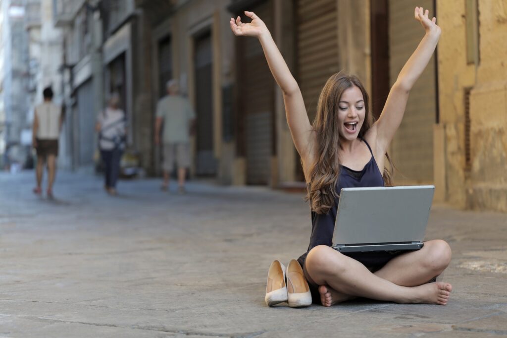 Woman Raising Her Hands Up While Sitting On Floor With 3813341 1024x682